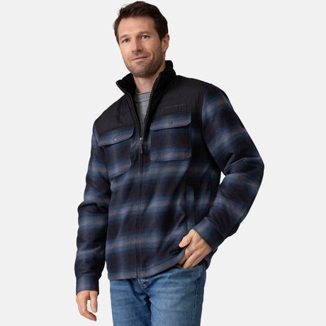 [Vince is 6'1" wearing a size Medium.] Man wearing Free Country Men's Woodsman Work Jacket in blue and black plaid with a full front zipper opening, soft lining, and recycled polyester filling, light grey background. Perfect men’s jacket for fall weather.