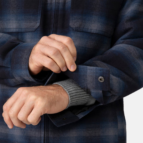 [Vince is 6'1" wearing a size Medium.] Man wearing Free Country Men's Woodsman Work Jacket in blue and black plaid with a full front zipper opening, soft lining, and recycled polyester filling, light grey background. Perfect men’s jacket for fall weather.