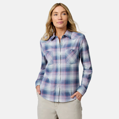 [Model is wearing size S.] A woman modeling a long-sleeve plaid button-up shirt in shades of purple, blue, and white, paired with beige pants, against a light gray studio background.