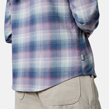 [Model is wearing size S.] Close-up of a person wearing a long-sleeve plaid flannel shirt in blue, purple, and white, paired with beige cargo pants against a light gray studio background.