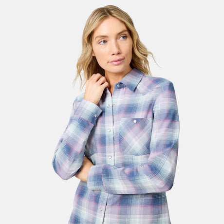 [Model is wearing size S.] A woman modeling a long-sleeve plaid button-up shirt in shades of blue, pink, and white, set against a solid light gray background.
