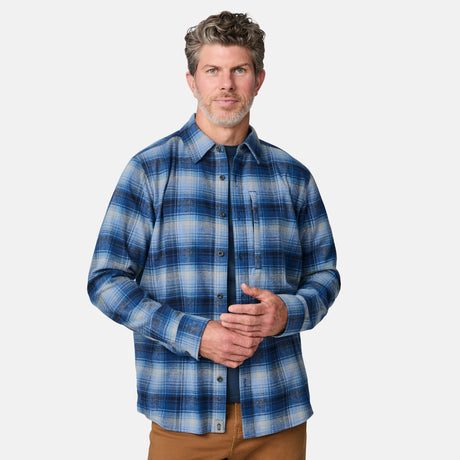 [Kolby is 6'2" wearing size M.] Men’s blue and white plaid button-up shirt with long sleeves, chest pocket, and collar — styled with brown pants for a classic casual look