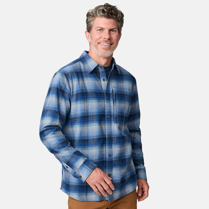 [Kolby is 6'2" wearing size M.] Men’s blue and white plaid button-up shirt with long sleeves, chest pocket, and collar — styled with brown pants for a classic casual look