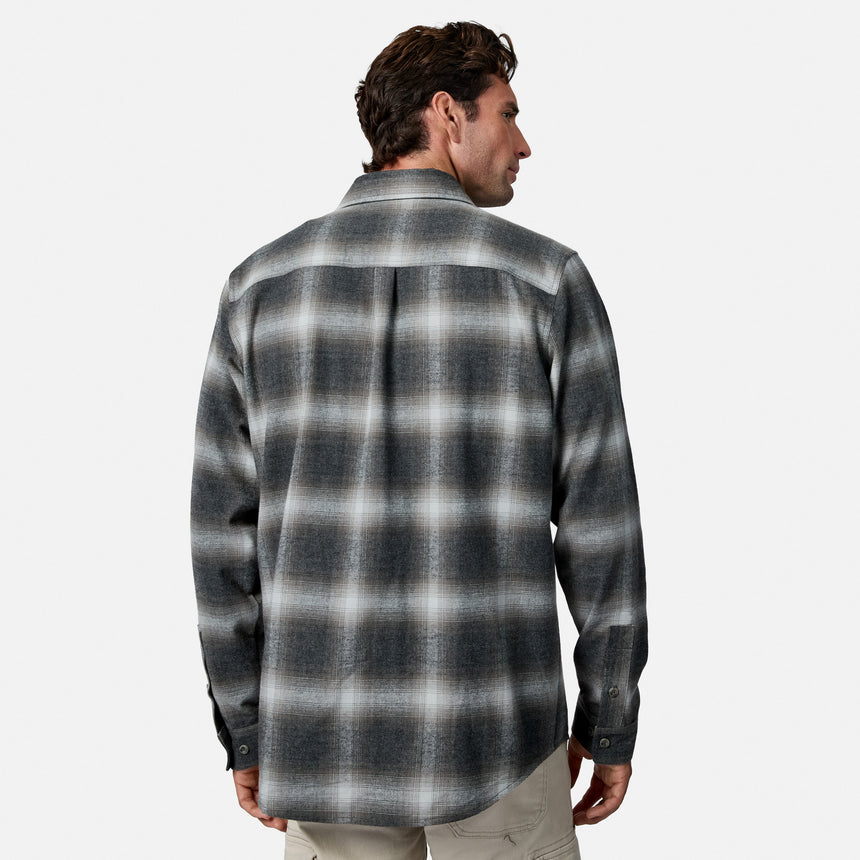 [Model is wearing size M.] A man shown from the back wearing a long-sleeve plaid button-up shirt in dark gray and white, paired with light khaki pants, against a plain light gray background.