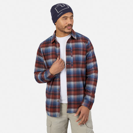 A man wearing a blue beanie and a red and blue plaid Free Country Men’s Easywear Flannel Shirt over a white t-shirt.