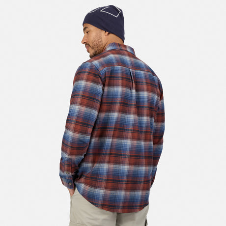A person viewed from the back wearing a blue and red plaid Men’s Easywear Flannel Shirt with a chest zipper pocket and a navy beanie.