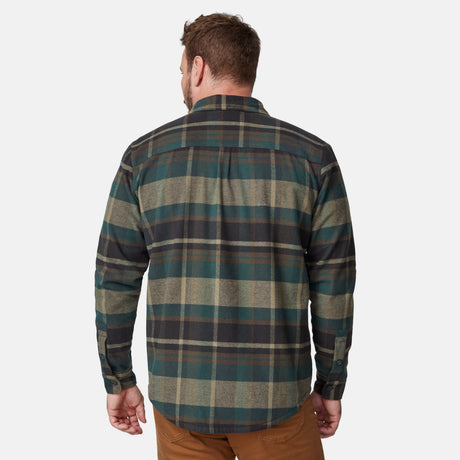 A man is seen from the back in a Free Country Men's Easywear II Fleece Lined Flannel Shirt—lightweight, green, blue, and beige plaid with long sleeves—paired with brown pants against a plain white background.