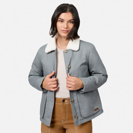 [Model is wearing size S.] A woman wearing a light gray utility jacket with a white sherpa collar, a beige top, and brown pants, photographed against a light gray studio background.