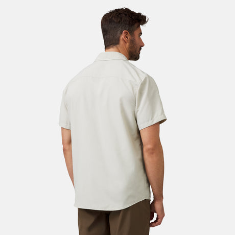 A man with short brown hair faces away, wearing the Clearance Men's Expedition Nylon Rip-Stop Short Sleeve Shirt and brown pants against a plain white background.