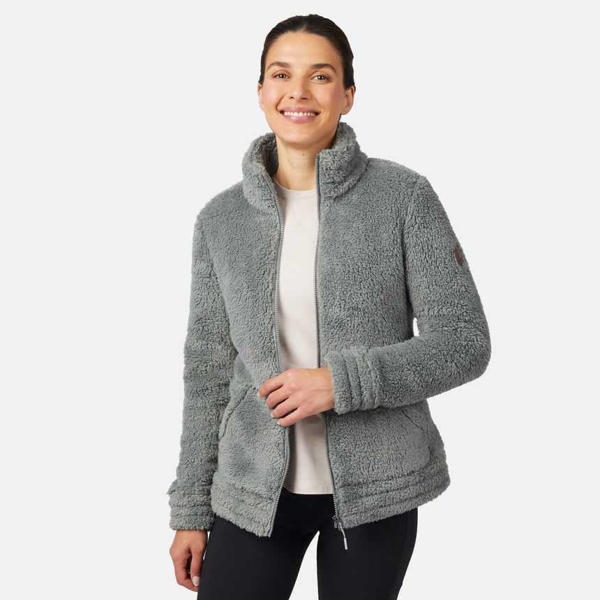 Woman wearing a gray/green fleece jacket on a white background
