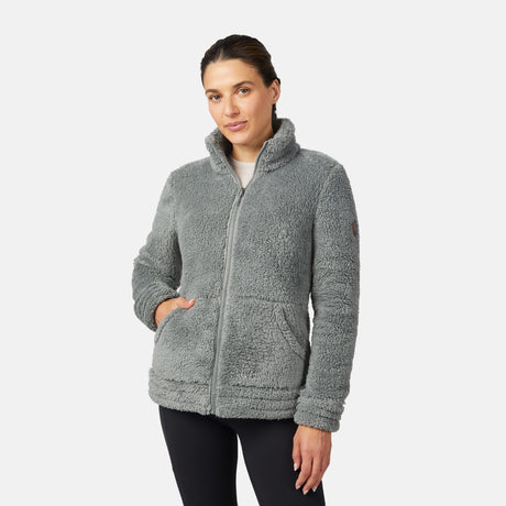 Woman wearing a gray/green fleece jacket on a white background