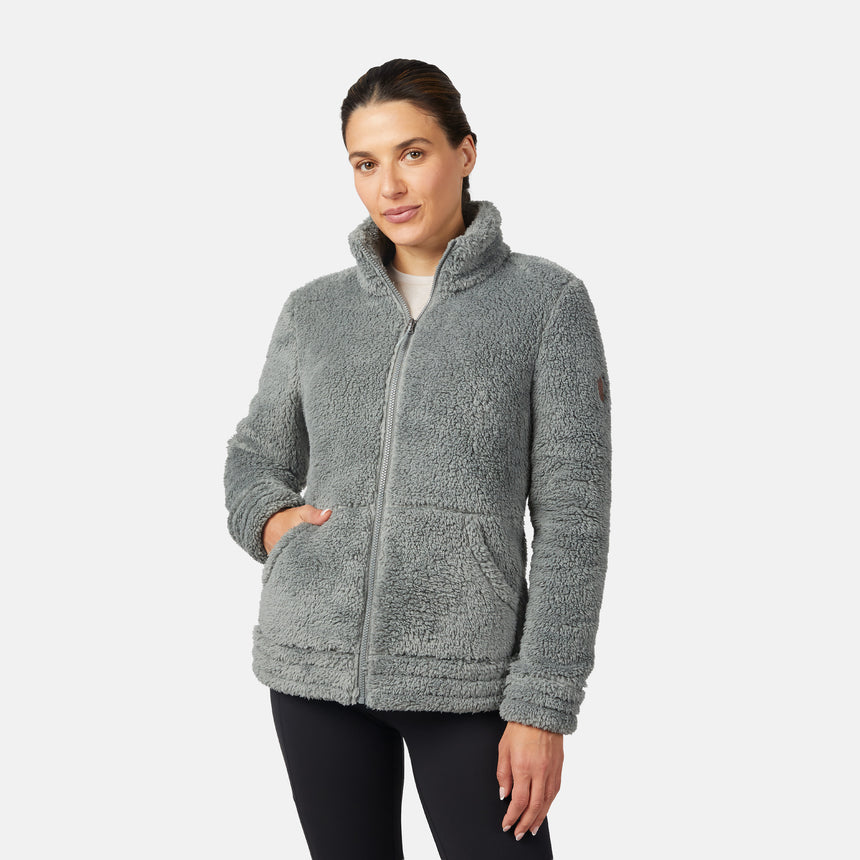 Woman wearing a gray/green fleece jacket on a white background