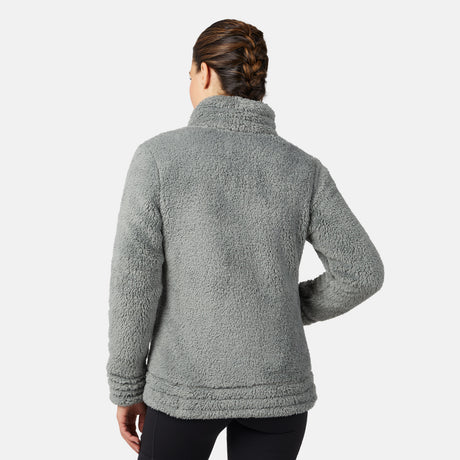 Person wearing a gray/green fleece jacket on a white background