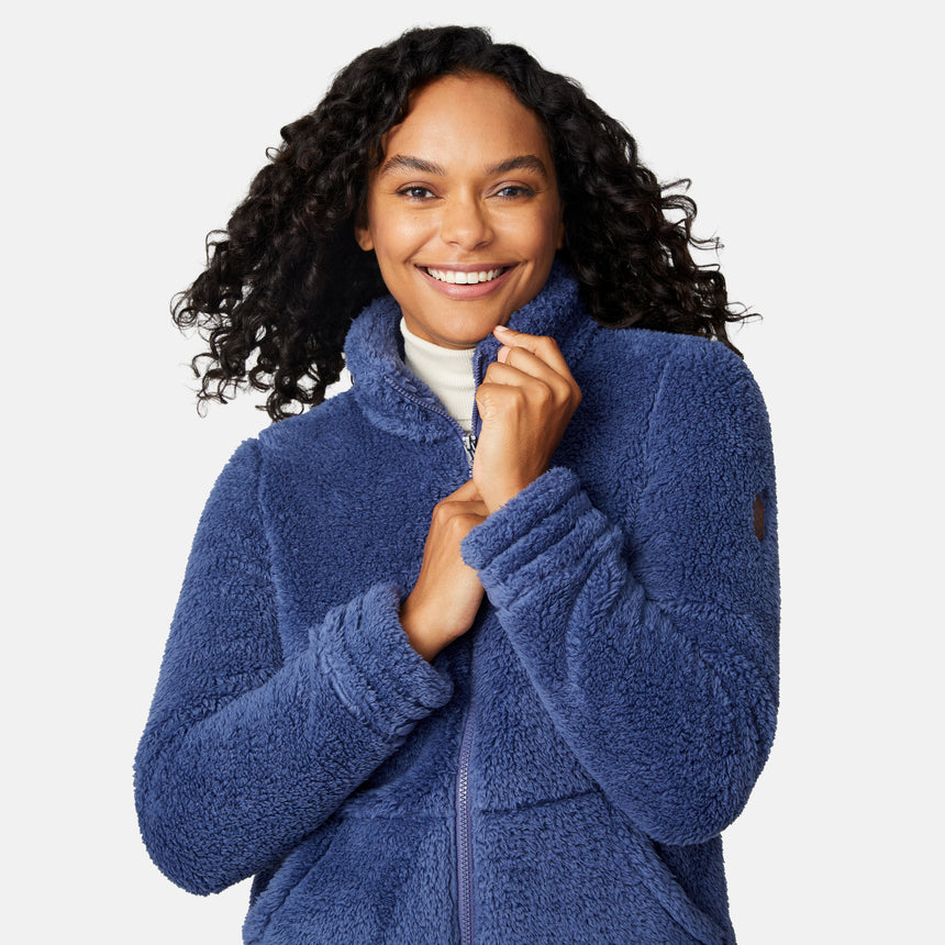Woman wearing a blue fleece jacket on a white background