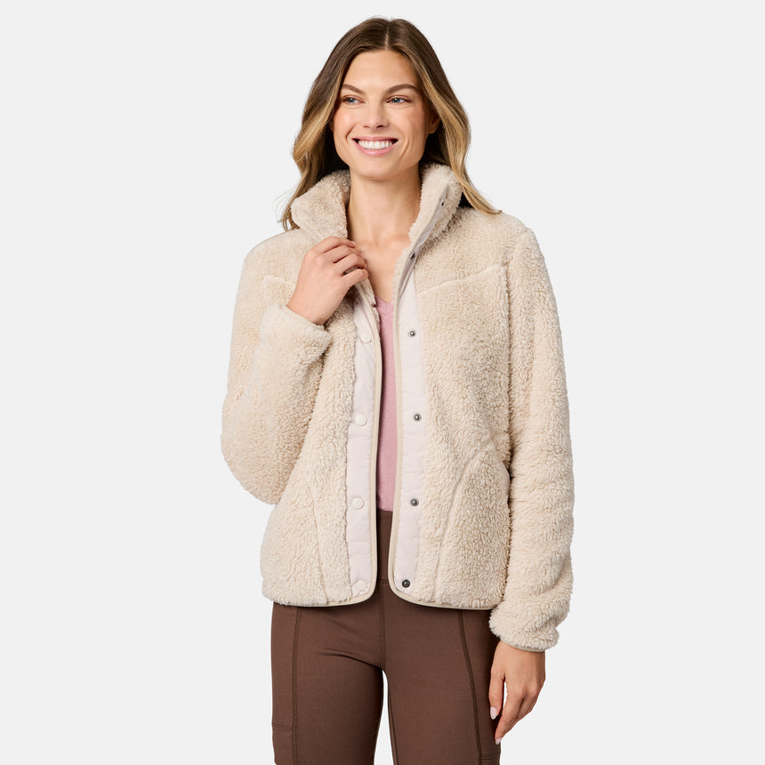 [Model is wearing size S.] A woman modeling a cream sherpa fleece button-up jacket with a high collar, shown against a plain light gray studio background.