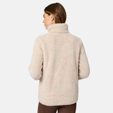 [Model is wearing size S.] A woman shown from the back wearing a cream-colored sherpa fleece turtleneck sweater, paired with brown pants, against a plain white background.