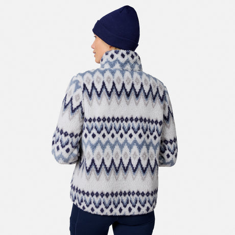 [Model is wearing size S.] A person shown from the back wearing a fuzzy knit mock-neck fleece jacket with a blue and white geometric pattern, paired with a navy beanie and navy pants, against a light gray studio background.