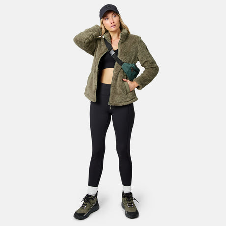 Model wearing olive green Women's Sierra Sherpa Pile Zip Up Jacket with black top and green crossbody bag.