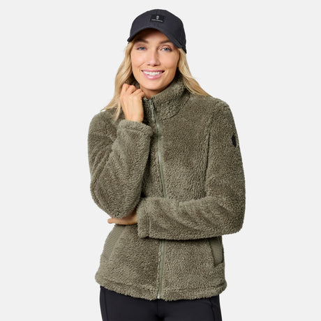 Woman in a taupe Sierra Sherpa Pile Zip Up Jacket with a full front zipper and stand collar