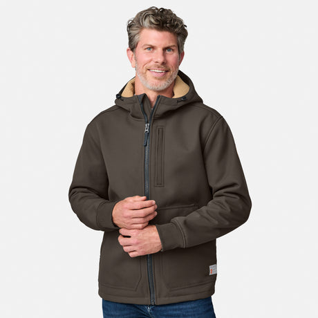 [Kolby is 6'2" wearing size M.] Men’s Free Country brown hooded jacket featuring full front zipper, two side pockets, and zippered chest pocket. Includes utility patch on left sleeve and subtle brand label at lower hem. Styled with blue jeans for a laid-back cold-weather look highlighting functional design and casual edge.