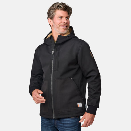 [Kolby is 6'2" wearing size M.] Men’s Free Country black hooded jacket featuring full front zipper, two side pockets, and zippered chest pocket. Includes utility patch on left sleeve and subtle brand label at lower hem. Styled with blue jeans for a laid-back cold-weather look highlighting functional design and casual edge.