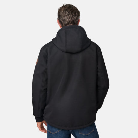 [Kolby is 6'2" wearing size M.] Men’s Free Country black hooded jacket featuring full front zipper, two side pockets, and zippered chest pocket. Includes utility patch on left sleeve and subtle brand label at lower hem. Styled with blue jeans for a laid-back cold-weather look highlighting functional design and casual edge.