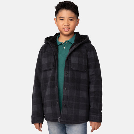[Model is wearing a size Medium.] Boy wearing the Free Country Boys' Chill Out Fleece Jacket in red and grey plaid with a hood, standing with hands in jeans pockets against a plain light gray background.