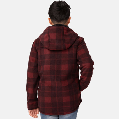 [Model is wearing a size Medium.] Boy wearing the Free Country Boys' Chill Out Fleece Jacket in red and black plaid with a hood, standing with hands in jeans pockets against a plain light gray background.