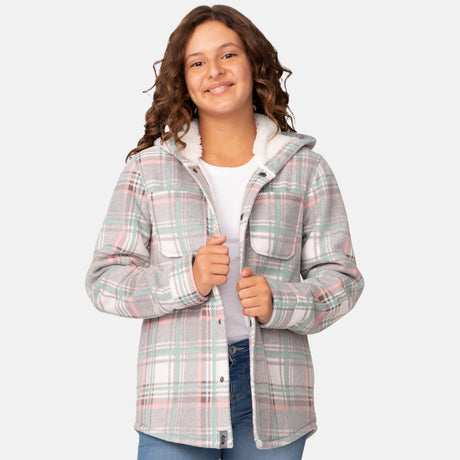[Model is wearing a size Medium.] Girl wearing the Free Country Girls' Chill Out Fleece Jacket in teal, pink, and grey plaid with a hood, standing with hands in jeans pockets against a plain light gray background.