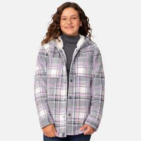[Model is wearing a size Medium.] Girl wearing the Free Country Girls' Chill Out Fleece Jacket in purple and grey plaid with a hood, standing with hands in jeans pockets against a plain light gray background.
