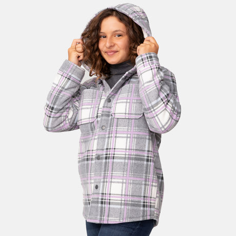 [Model is wearing a size Medium.] Girl wearing the Free Country Girls' Chill Out Fleece Jacket in purple and grey plaid with a hood, standing with hands in jeans pockets against a plain light gray background.