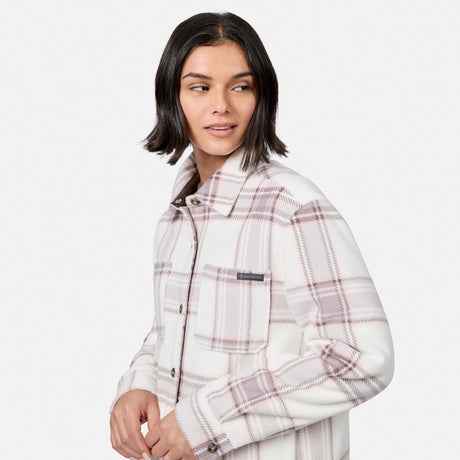 [Model is wearing size S.] A woman wearing a white and dusty pink plaid button-up shirt jacket with a soft fleece lining, photographed against a solid light gray background.