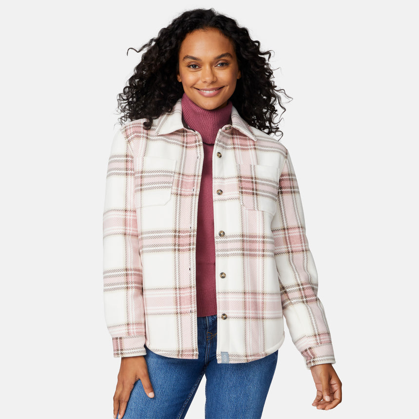 [Angelique is 5'10" wearing size S.] Woman wearing a pink plaid shirt over a turtleneck with a white background