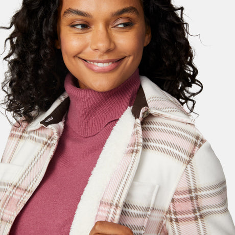 [Angelique is 5'10" wearing size S.] Woman wearing a pink plaid shirt over a turtleneck with a white background