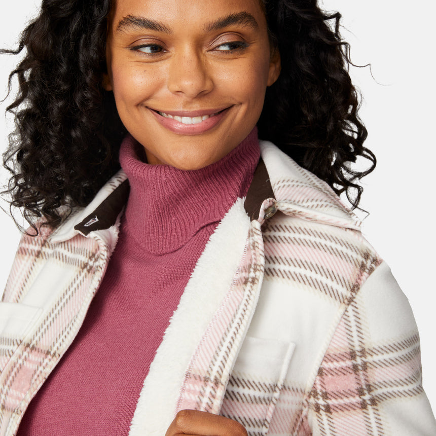 [Angelique is 5'10" wearing size S.] Woman wearing a pink plaid shirt over a turtleneck with a white background