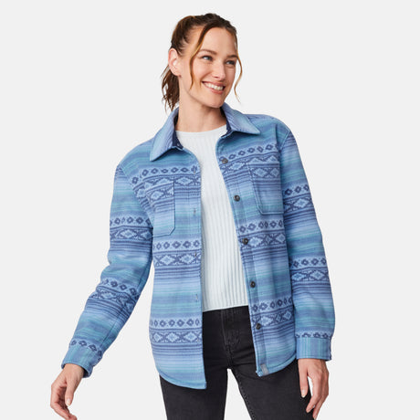 [Model is wearing size S.] A woman wearing a blue patterned button-up shirt jacket over a white ribbed top and black jeans, photographed against a light gray studio background.