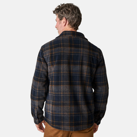 [Kolby is 6'2" wearing size M.] Men’s Free Country plaid button-down shirt in blue and brown checkered pattern, featuring dual chest pockets with button flaps and a relaxed fit. Paired with brown pants for a casual fall-ready look, ideal for outdoor layering.