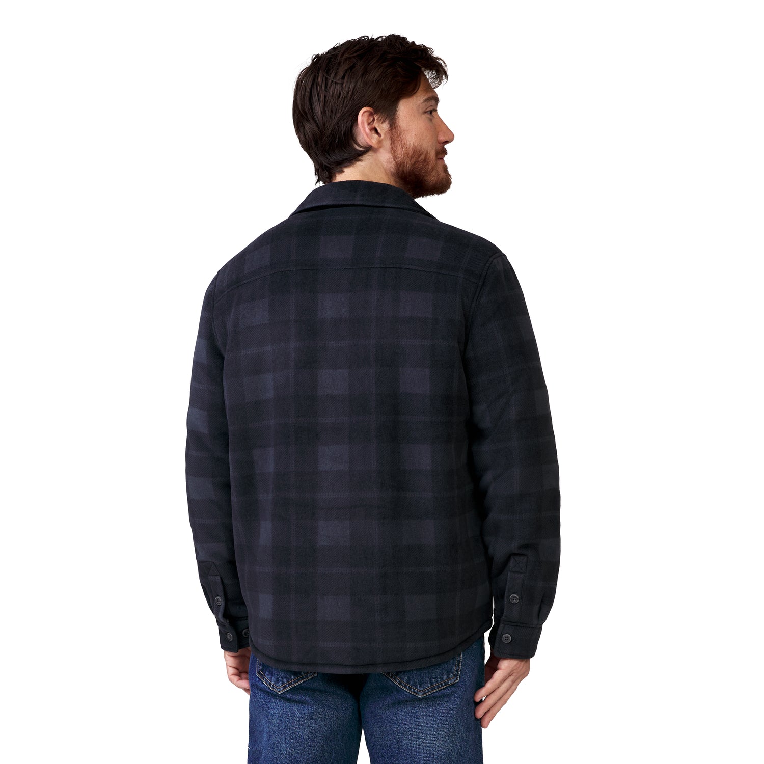 A man seen from behind wearing a black and gray plaid Men’s Chill Out Fleece Shirt Jacket and blue jeans.