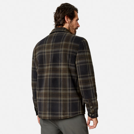 A man with dark hair is seen from the back, wearing the Free Country Men’s Chill Out Fleece Shirt Jacket in a black and olive plaid pattern, set against a plain white background.