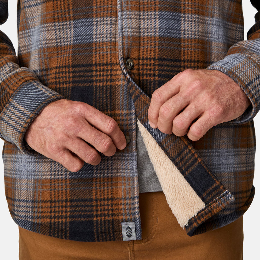[Kolby is 6'2" wearing size M.] Men’s long-sleeve plaid button-up shirt in brown, black, and gray — features dual chest pockets with button closures and a relaxed fit