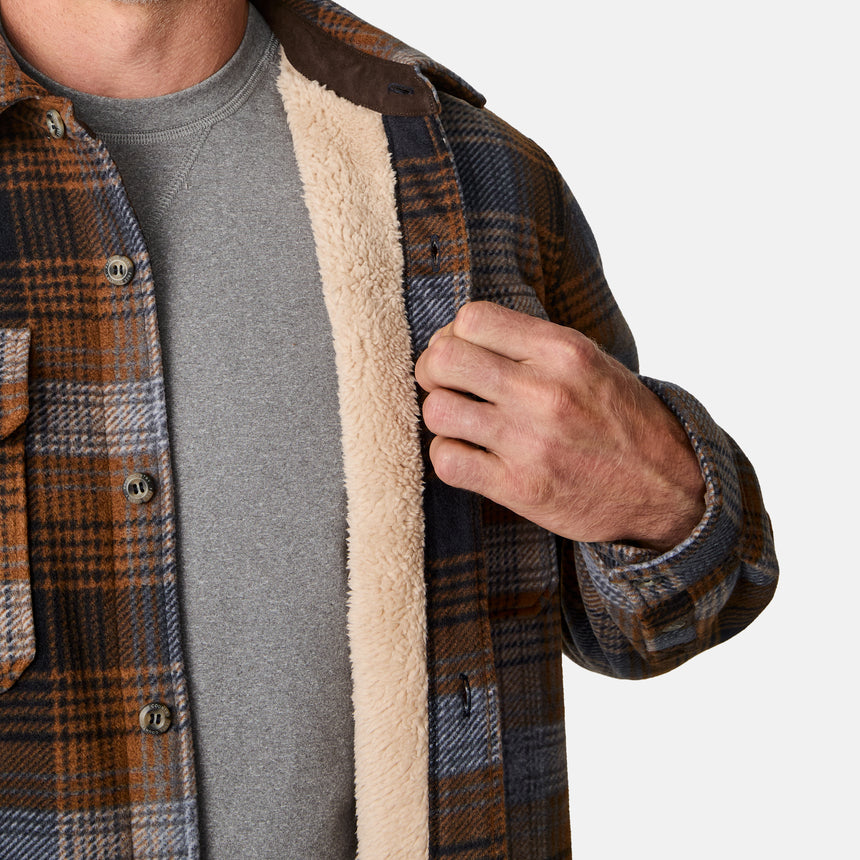 [Kolby is 6'2" wearing size M.] Men’s long-sleeve plaid button-up shirt in brown, black, and gray — features dual chest pockets with button closures and a relaxed fit