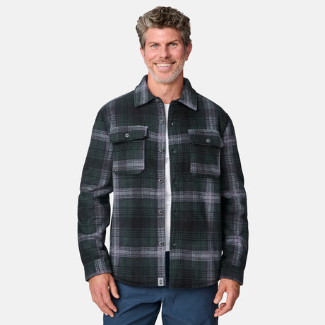 [Kolby is 6'2" wearing size M.] Men’s dark green and black plaid button-up shirt with flap chest pockets and button closures — rugged style with structured fit