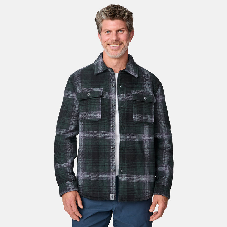 [Kolby is 6'2" wearing size M.] Men’s dark green and black plaid button-up shirt with flap chest pockets and button closures — rugged style with structured fit