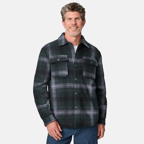 [Kolby is 6'2" wearing size M.] Men’s dark green and black plaid button-up shirt with flap chest pockets and button closures — rugged style with structured fit