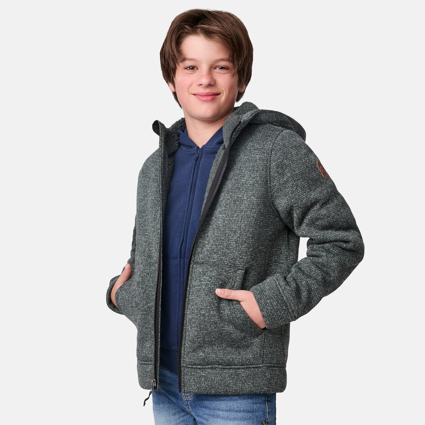 [River is wearing size M.] Model wearing a green-grey textured zip-up hoodie with front hand pockets and an adjustable hood, styled with blue jeans; cozy and casual layering ideal for cool-weather errands or outdoor lounging.