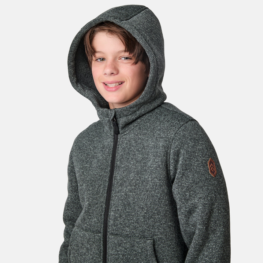 [River is wearing size M.] Model wearing a green-grey textured zip-up hoodie with front hand pockets and an adjustable hood, styled with blue jeans; cozy and casual layering ideal for cool-weather errands or outdoor lounging.