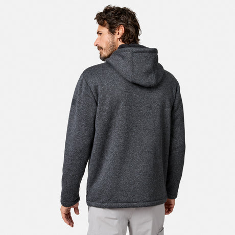 [Model is wearing size M.] A man with brown hair and a beard is wearing a dark gray Free Country Men’s Mountain Fleece Jacket and light gray pants, standing against a plain white background with his back to the camera.
