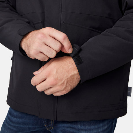 [Joe is 6’0” wearing size M.] Man wearing Free Country Men's Ski Patrol 3-in-1 Systems Jacket in black with a full front zipper opening, an outer jacket for wind and cold weather, an inner puffer jacket, and wind resistant and water resistant stretch performance fabric, light grey background. Perfect men’s jacket for winter weather.