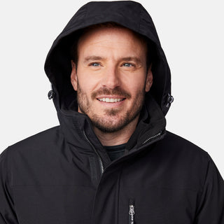 [Joe is 6’0” wearing size M.] Man wearing Free Country Men's Ski Patrol 3-in-1 Systems Jacket in black with a full front zipper opening, an outer jacket for wind and cold weather, an inner puffer jacket, and wind resistant and water resistant stretch performance fabric, light grey background. Perfect men’s jacket for winter weather.