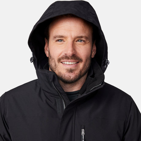[Joe is 6’0” wearing size M.] Man wearing Free Country Men's Ski Patrol 3-in-1 Systems Jacket in black with a full front zipper opening, an outer jacket for wind and cold weather, an inner puffer jacket, and wind resistant and water resistant stretch performance fabric, light grey background. Perfect men’s jacket for winter weather.